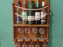Rustic, repurposed pine and rope wall-mounted bottle rack with wine glass shelf