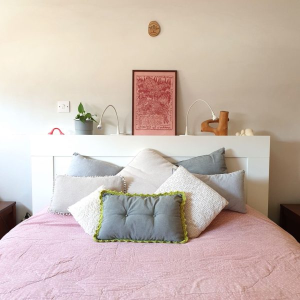 green & grey buttoned comfort cushion - in use bedroom