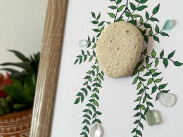 A lovely hanging floral arrangement, made with seaglass pieces and a pebble, perfect as a thoughtful gift!