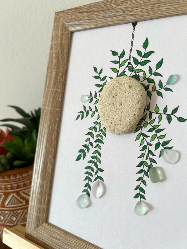 A lovely hanging floral arrangement, made with seaglass pieces and a pebble, perfect as a thoughtful gift!
