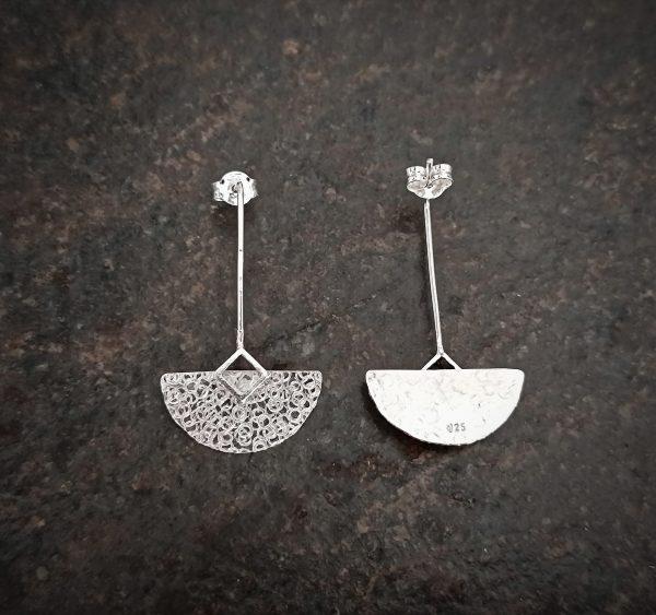silver earrings with geometric patterns