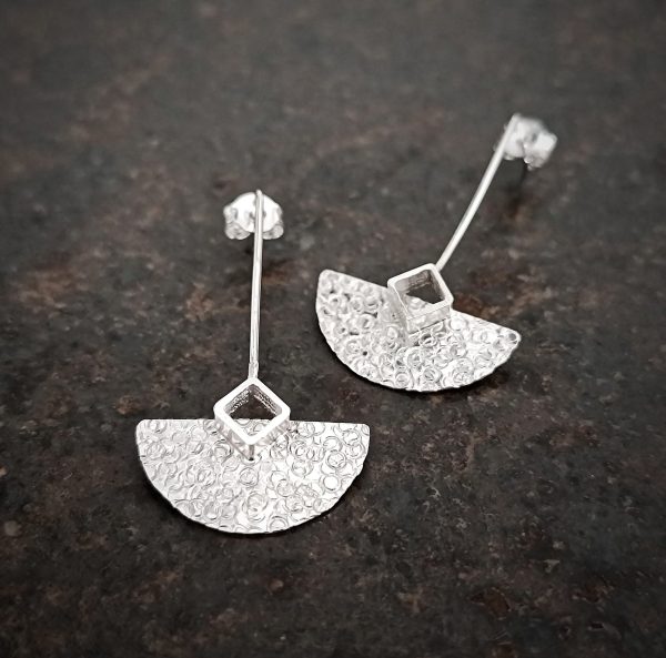 silver earrings with geometric patterns