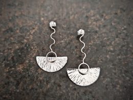silver earrings with geometric patterns