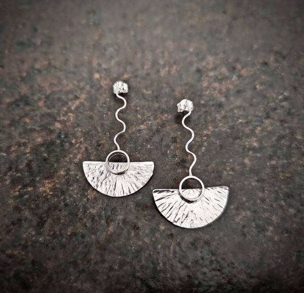 silver earrings with geometric patterns