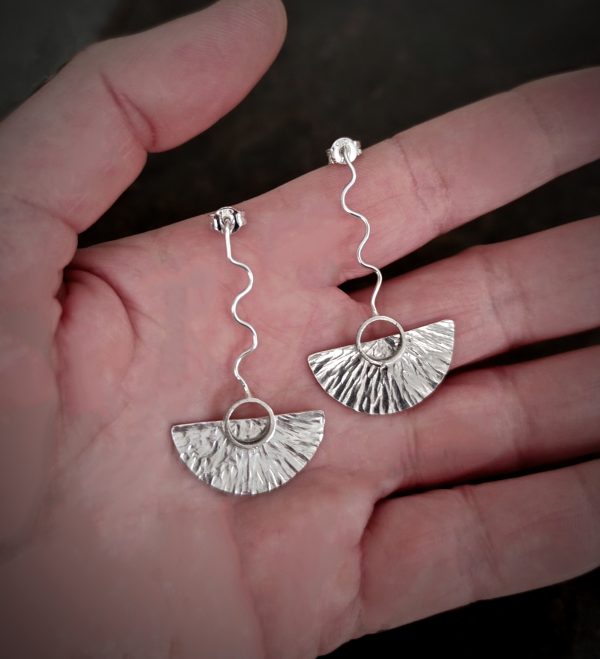 silver earrings with geometric patterns