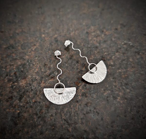 silver earrings with geometric patterns