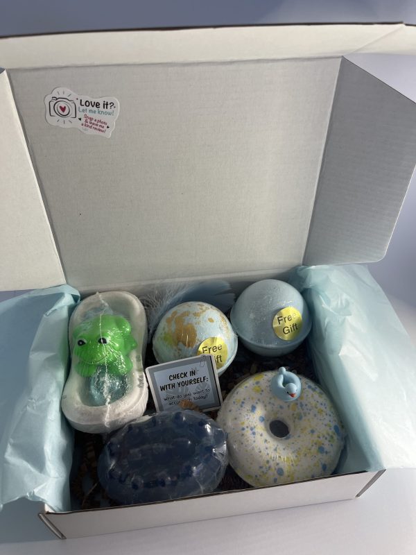 Box with four bath bombs and one natural massage soap