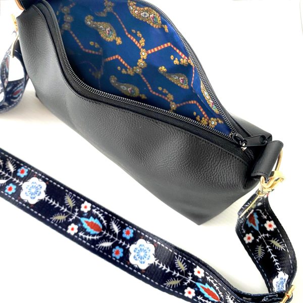 black messenger bag with bohemian strap inside