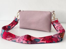 pink messenger bag with floral strap front